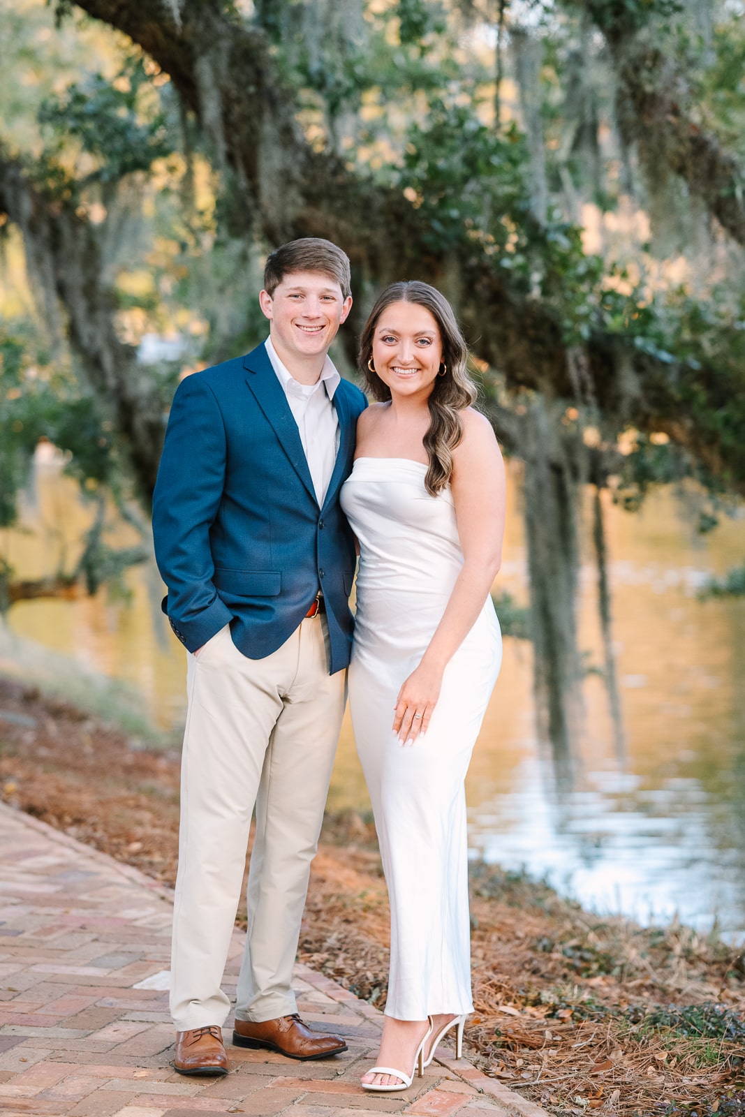 couple poses for engagent photos at the Grand Hotel in Fairhope Al