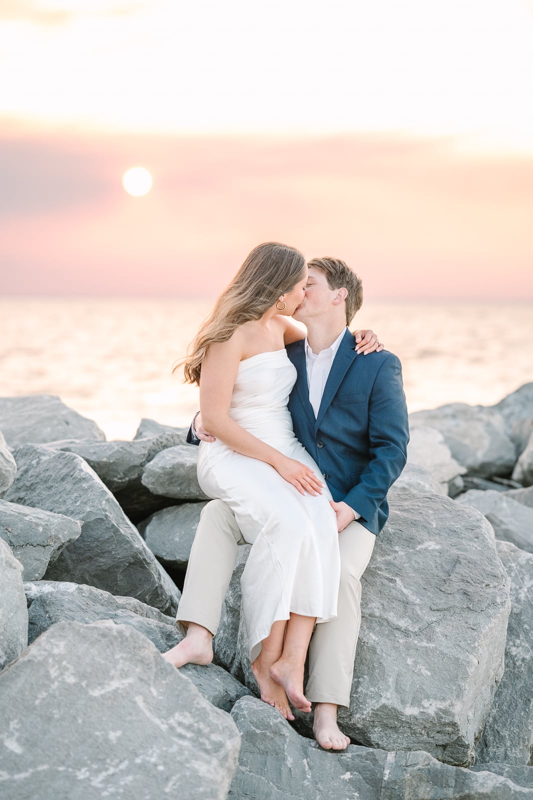 couples kisses at sunset during engagement photos in Fairhope