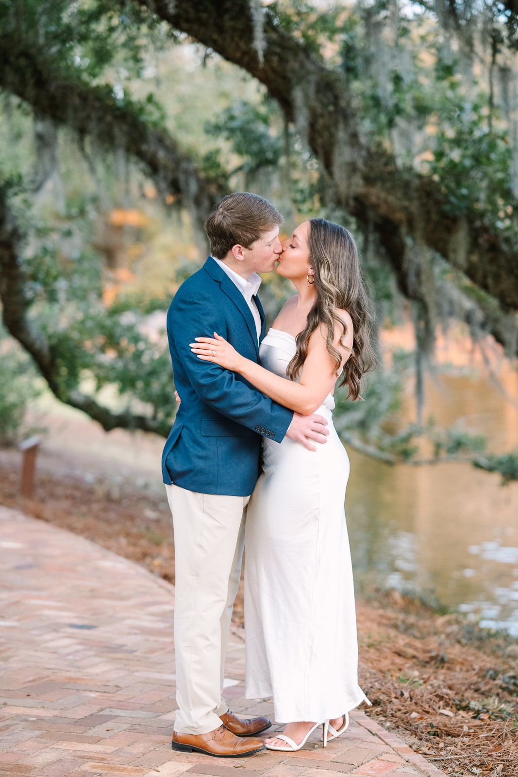 Couple kisses for engagement photo in Fairhope Alabama
