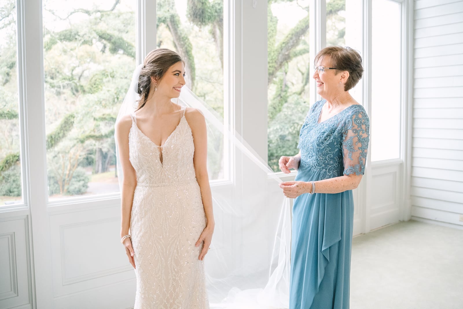 mom helping bride with veil at Bragg Mitchell Mansion