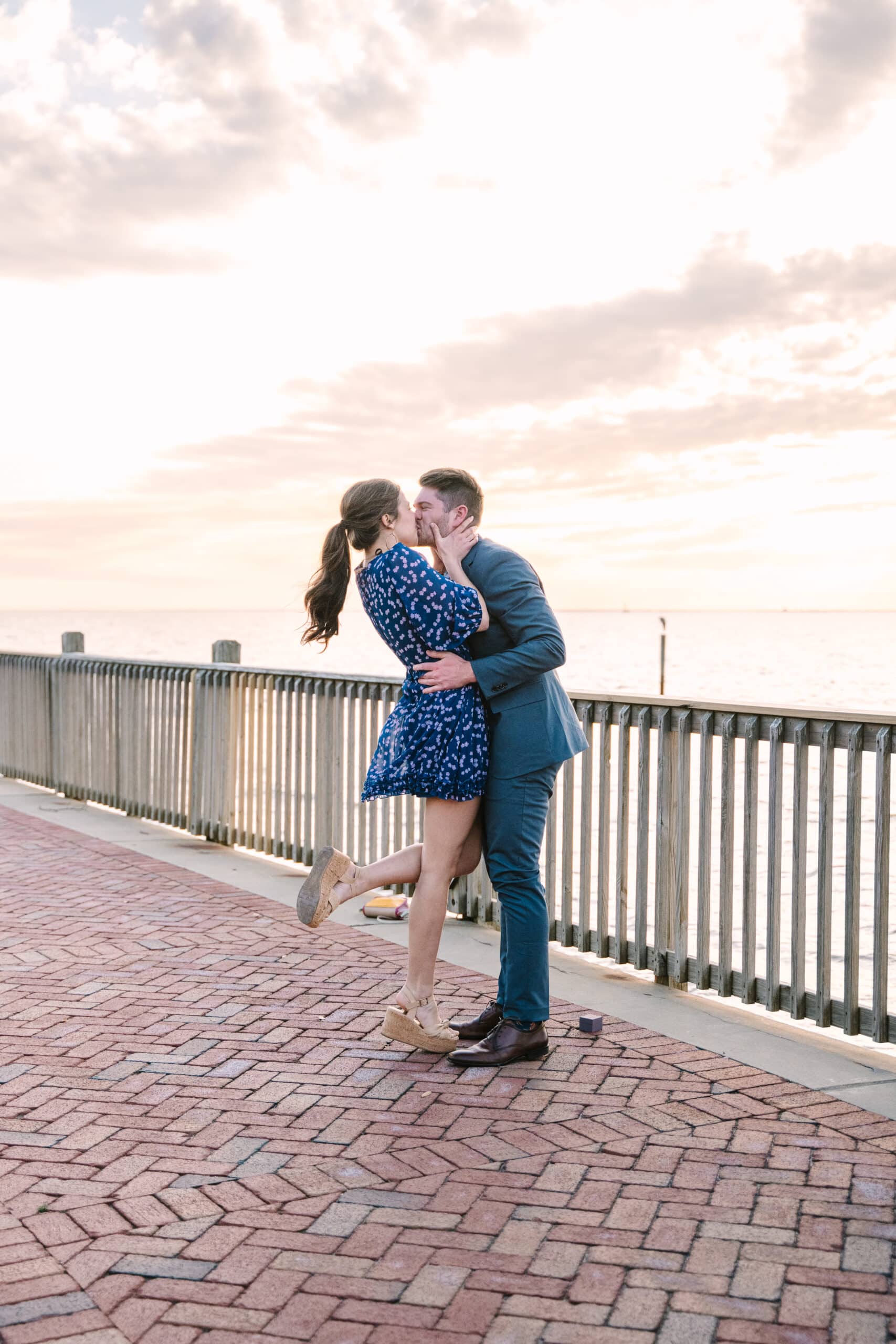 Couple kisses during proposal with Anne Canon Photography at The Grand Hotel